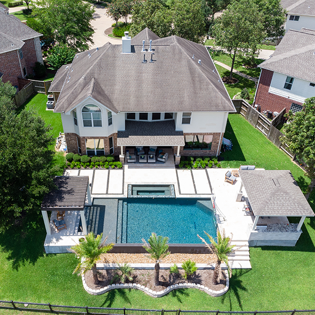 aerial view of a pool and backyard
