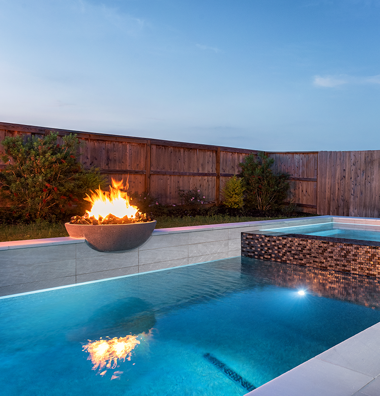 fire bowl and spa next to pool