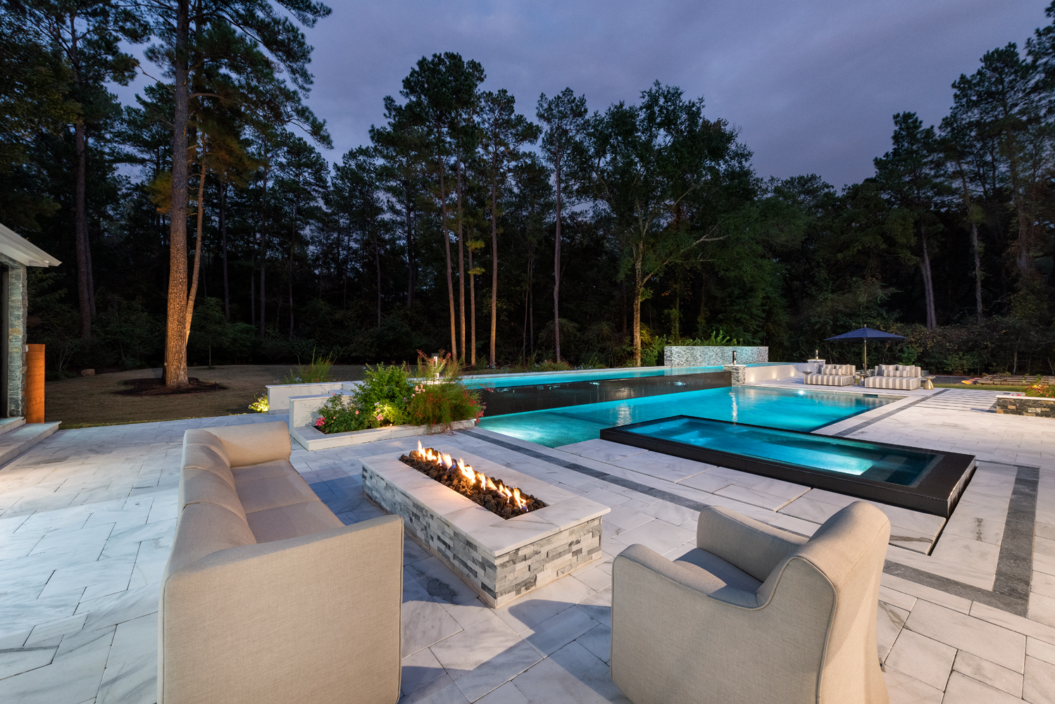 an elegant pool and patio at night