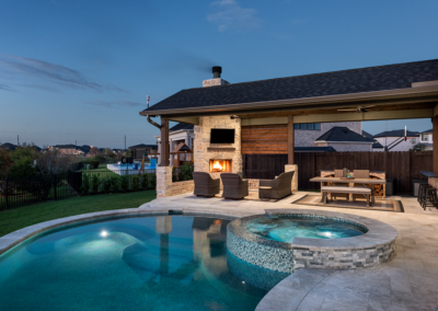 a pool and outdoor living area in the evening