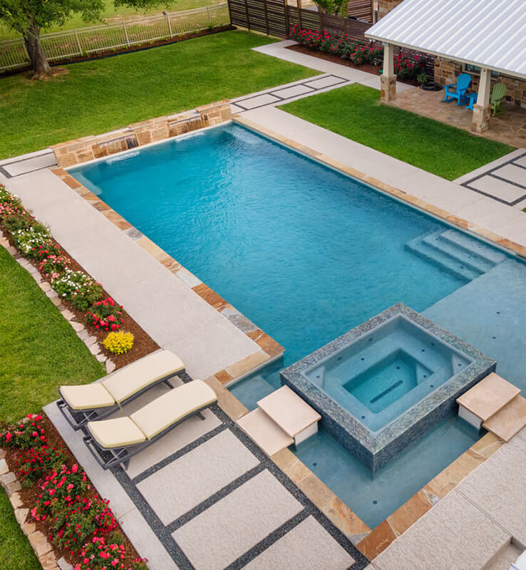 a pool and arbor at night