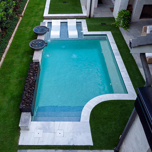 a pool and arbor at night