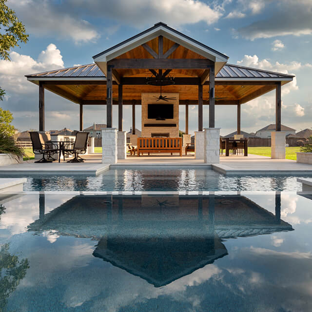 a pool and arbor at night