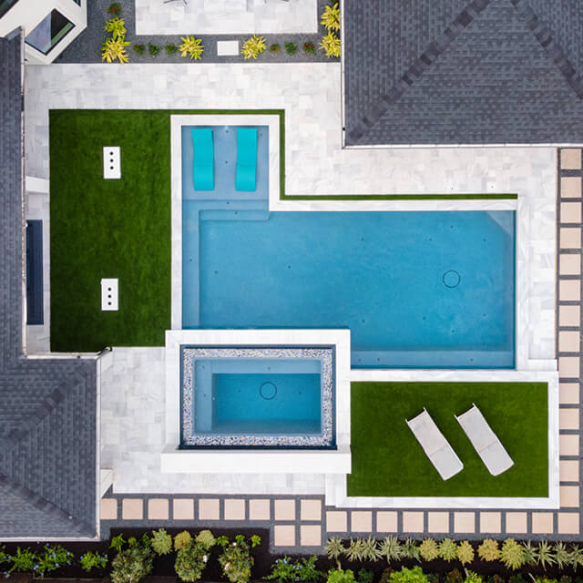 a pool and arbor at night