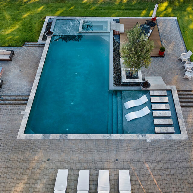 a pool and arbor at night