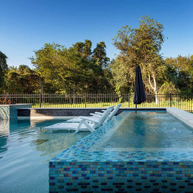 a pool and arbor at night