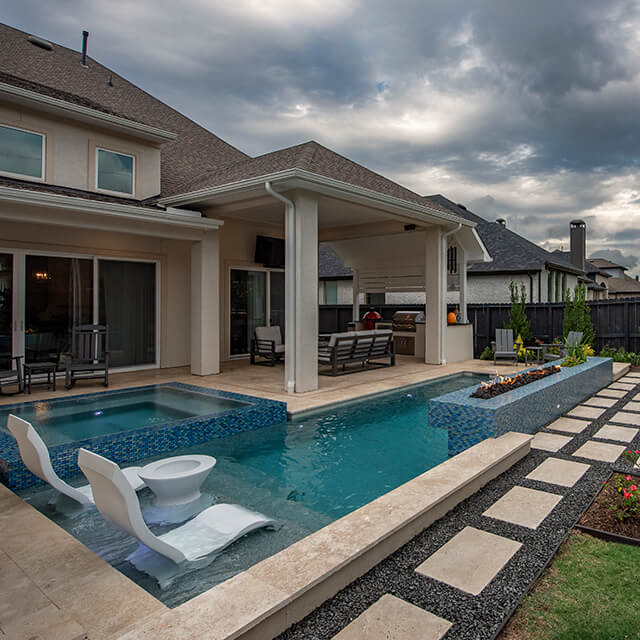 a pool and arbor at night