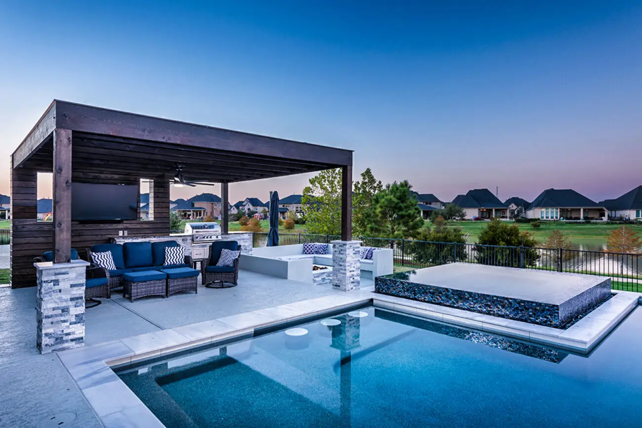 a pool with a deck and chairs - houston, tx