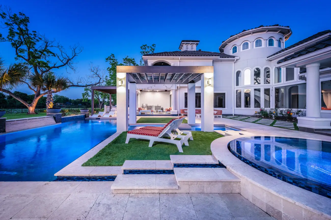 a pool and a house with a deck chair - houston, tx