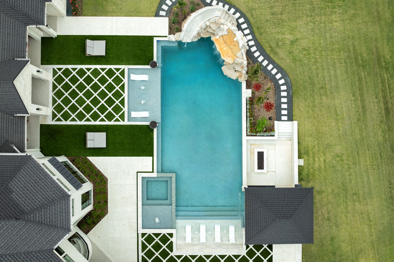 Bird’s-eye view of luxurious backyard with pool and spa combo