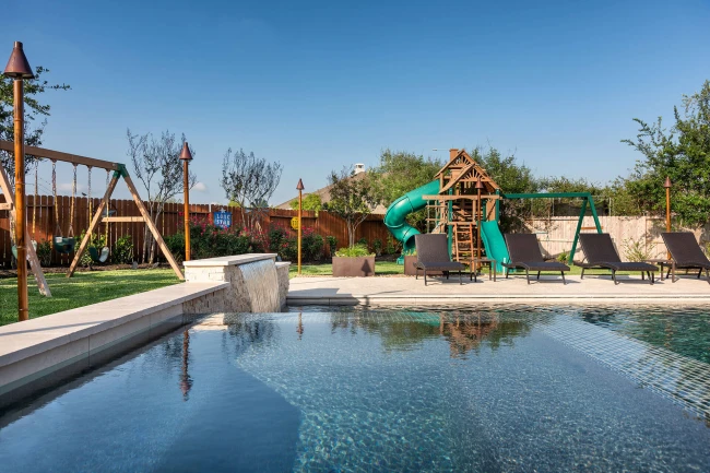 Modern custom pool with raised spa and sheer descent water features