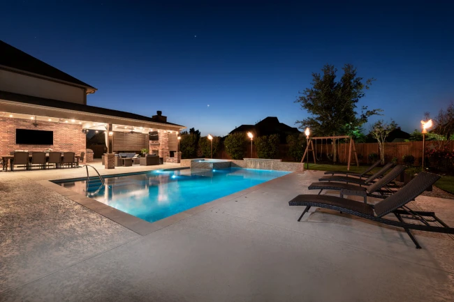 Modern custom pool with integrated spa and LED lighting
