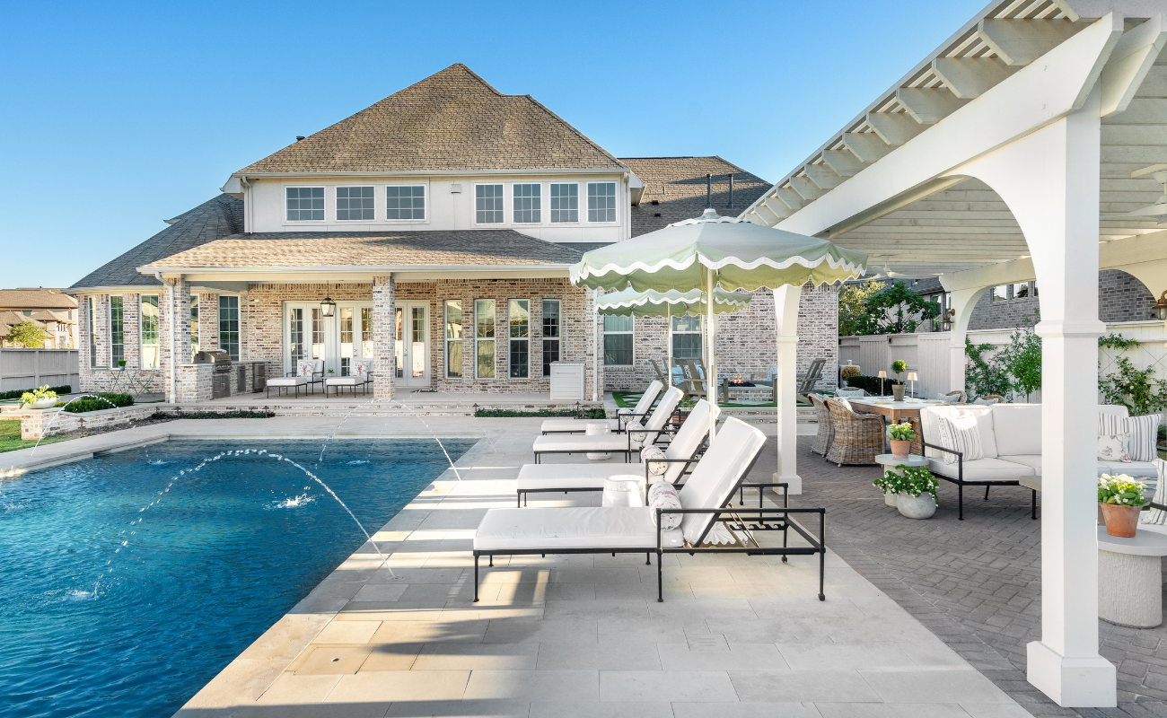 Modern backyard with a custom pool for new home build integrated with a pergola and outdoor living space.