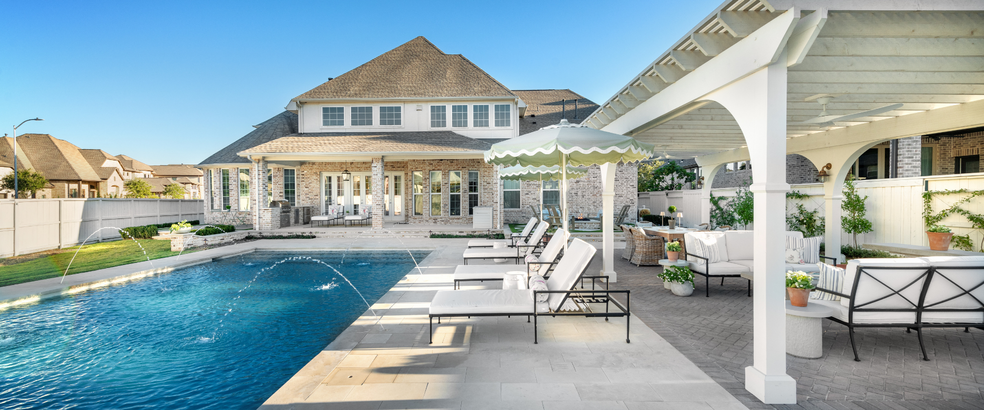 Modern backyard with a custom pool for new home build integrated with a pergola and outdoor living space.